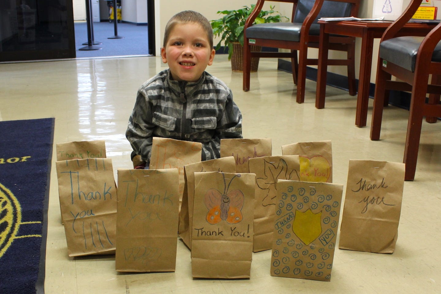 Home-schooled 4-year-old Levi Knutson poses in the Crestview Police Department lobby with bags of cookies he and his friends decorated and distributed to Crestview public safety agencies. [BRIAN HUGHES | Crestview Police Department]
