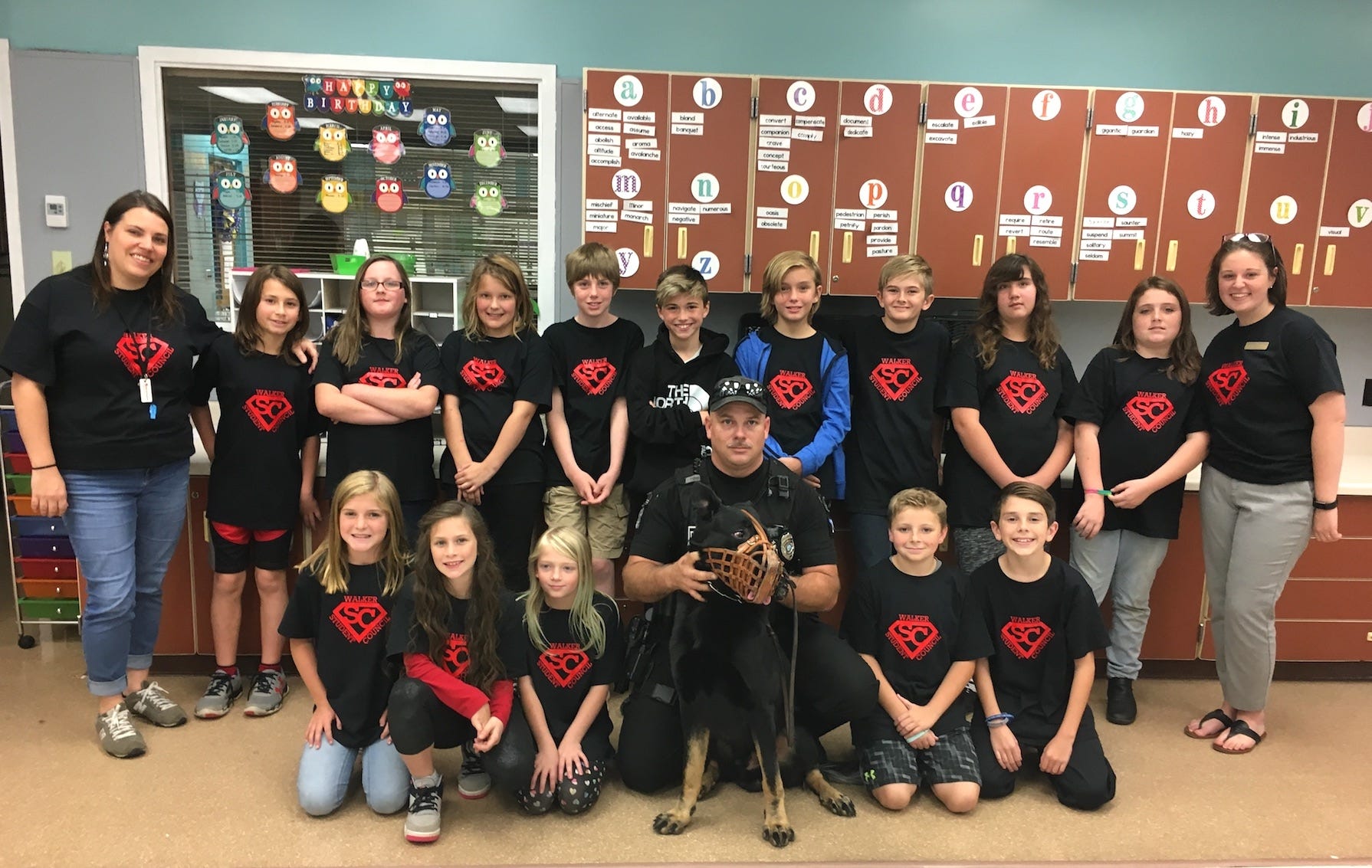 Crestview Police K9 Officers Jay Seal and Sonic visited the Walker Elementary School student council Nov. 16, including (front row) Alyssa, Meilana, Chloe, Carter and Mason; and (second row) teacher Ashley Grice, Brandon, Skylar, Maureen, Sean, Za’Vinci, Gage, Josiah, Alex, Caitlyn and student council adviser Elizabeth Springle. [BRIAN HUGHES | Crestview Police Department]