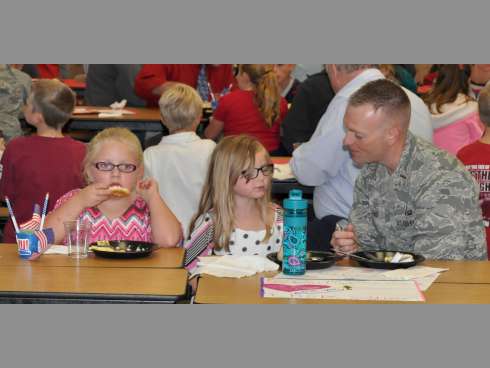 From left, Keyleigh Haws and her sister, Rebecka, join their father, Derek, for breakfast.