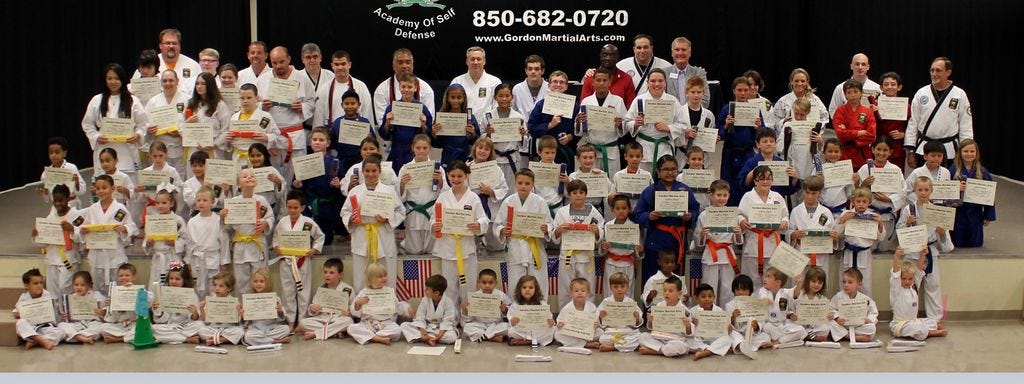 Gordon Martial Arts promoted its members during a July 1 ceremony at the Crestview Community Center. Bottom row: Mitchell Floyd, Kennedy Collins, Carter Spangler, Katie Mitchell, Alvin Smith, Kylie Ostasiuk, Samual King, Alexandria Doherty, Christopher Long, Bryson Hewett, Jaycie Armstrong, Aiden Kincses, Kipten Zeisler, Landon McPhaul, Rylan Mavity, Rodrigo Martinez, Johren Chin, Zacharie LaGarde, Vylee Hubert, Lex Morrill and Eli McCraney. Next row:  Mahlei Jones, Dante Brown, Kyndall Morrill, Logan Dunn, Jeremiah Beaman, Benjamin Harrison, Chasity Bofonchik, Grace Hagler, Tristen Zeisler, Matthew Gahary, Daniel Clark, Sherlyn Garcia, Ryan Mitchell, Emily Cypret, Trent Tucker, Marek Celinski and Zachary Wenrich. Next row: Jordan Rayno, Jada Rayno, Summer Morgan, Phenix Mayo, Jaslene Cazares, Anthony Scotto, Emma Henderson, Karley Spangler, Faith Hope, Aiden Bealler, Noah Ostasiuk, Caden Mavity, Michael Golles, Kain Doebele, Ava Smith, Aubrey Smith, Jayden Duarte and Andi Steen. Next row: Melanie Ocasio, Stephanie Lynch, Paige Palmer, Devin Richardson, Ramon Martinez, Connor McClard, Kaelani Roeske, Haven Clark, Sam Cook, Troy Harman, Ariel Harman, Dalton Morgan, Caitlin LaGarde, David Griffith, Theodore Smith, Simon Smith and Greg Bledsoe. Top row: Dustin Richardson, Sean LaGarde, Richard Rounsaville, Laura Richardson, Jeremy Morgan, Brian Doherty, Alberto Barbon, Ian Rodriguez, Jimmy Acol, Jeffrey Lovretich, Kurtis Lynch, Charles Baugh, Tom Gordon, Wayne Harris, Charla Hicks, Mary Valdez and Mark Ostasiuk.