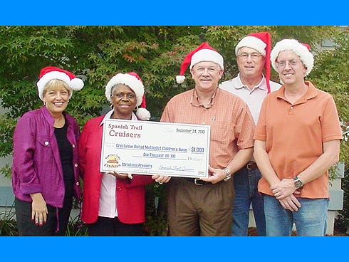Crestview United Methodist Children's Home spiritual care minister Mary Sims and group home supervisor Mae Knox receive a check for $1,000 from Spanish Trail Cruisers president, Mike Turman, secretary Doug Faircloth and vice president John Colby.