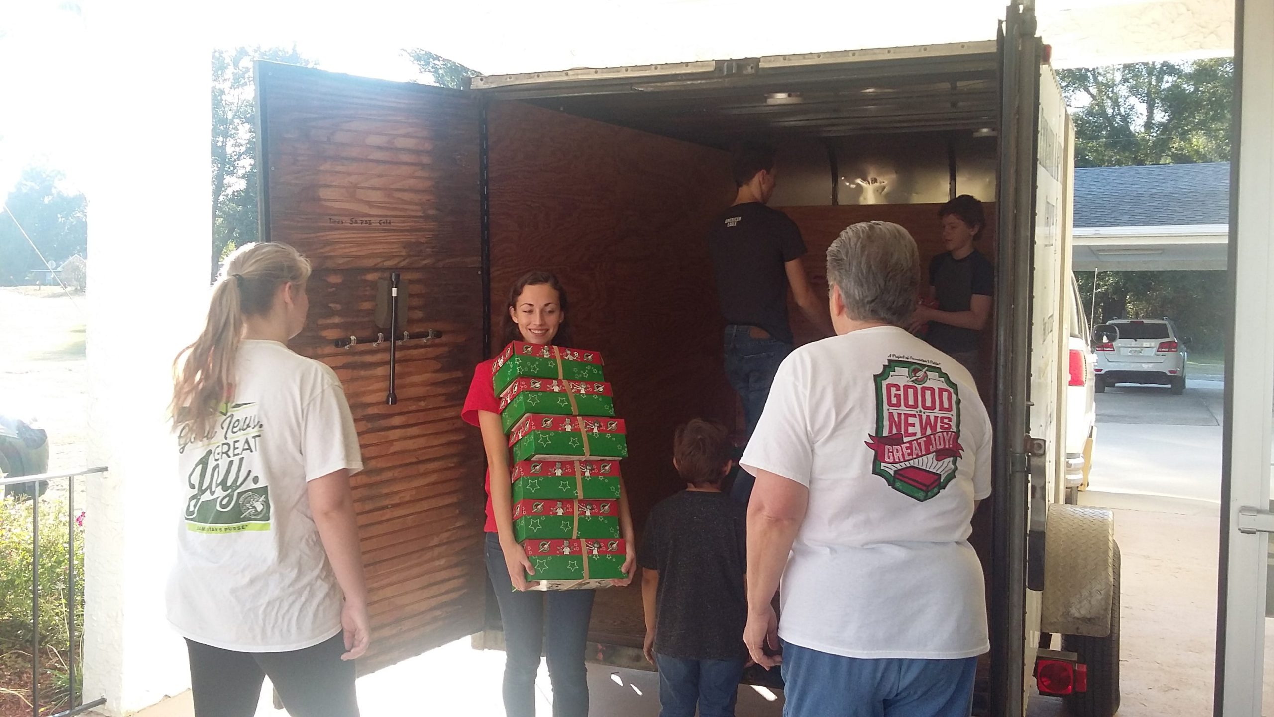Operation Christmas Child volunteers take time for a photo while loading a delivery truck. [SPECIAL TO THE NEWS BULLETIN]