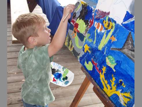 A boy creates art during last year's Family Fun Arts Fest at Henderson Beach State Park.