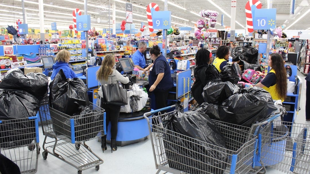 Some of more than 25 shopping cards full of toys for the Crestview Police Cops For Kids program go through two check-out lanes at the Crestview Wal-Mart Friday morning. When they were all tallied, 808 toys totaling $9,630 were purchased for almost 250 kids. [BRIAN HUGHES | Crestview Police Department]