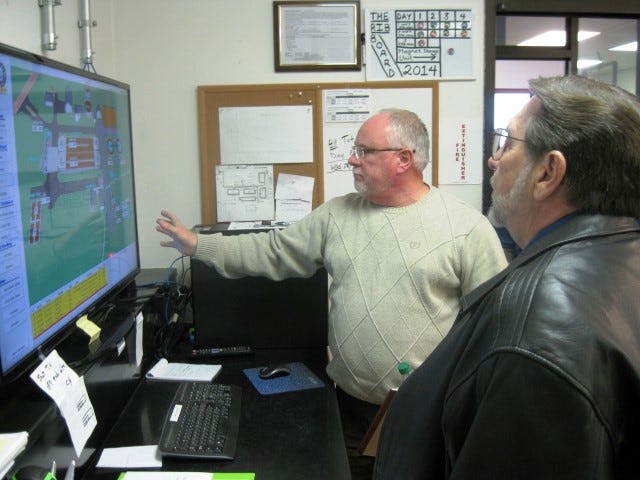 Public Works Director Wayne Steele explains the city wastewater treatment plant's workings to Mayor David Cadle during an open house to view the plant expansion's fourth phase.