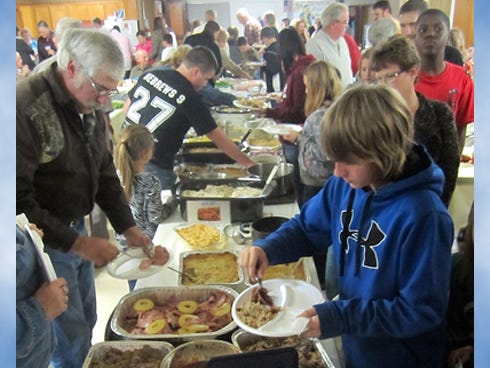 Laurel Hill residents eye the bounty offered during the community’s annual Harvest Supper. This year’s feast drew more than 150 people, one of the largest turnouts in recent history.