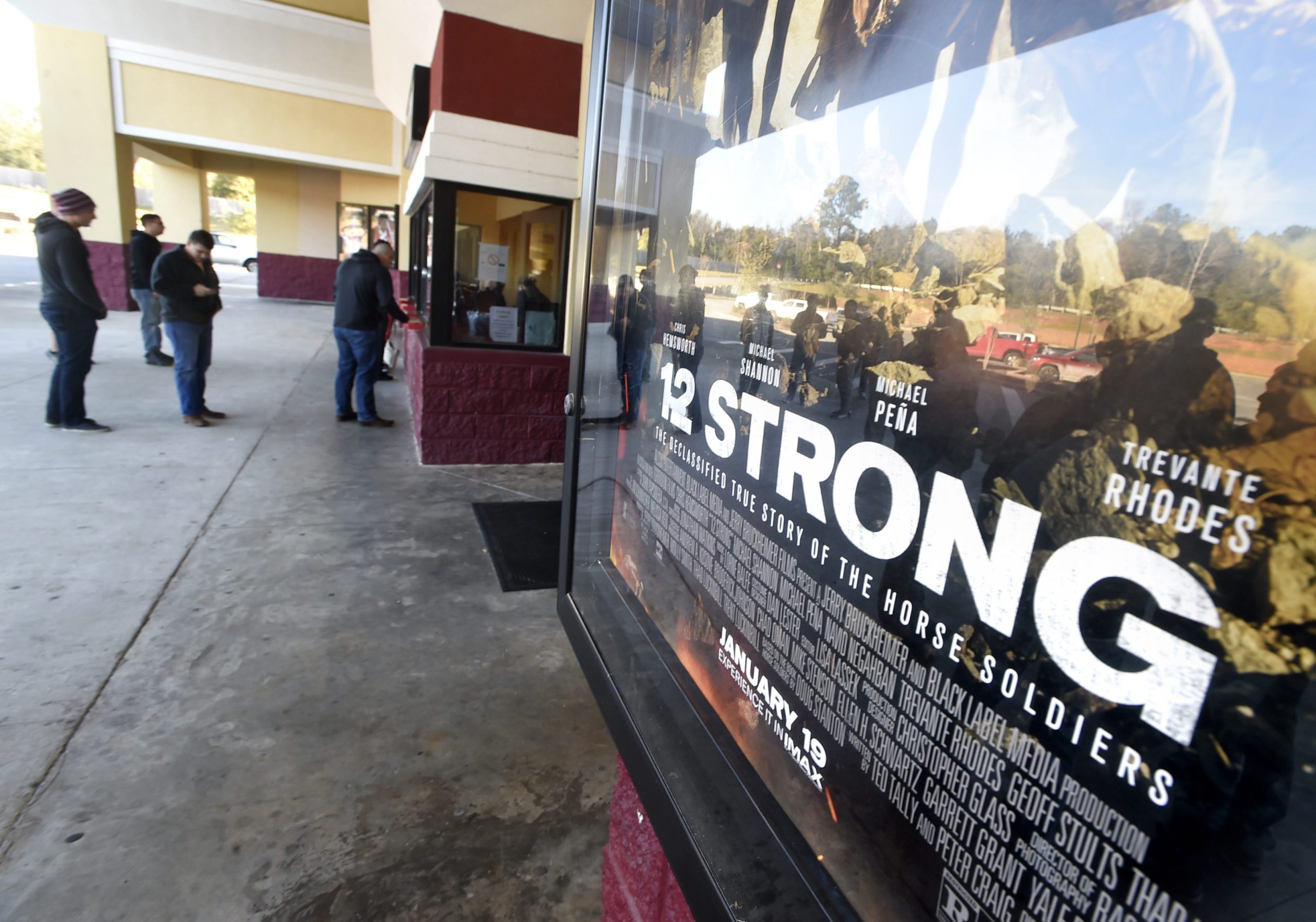 Soldiers from the 7th Special Forces Group purchase tickets at the Marquis Cinema in Crestview Friday morning for a special early screening of the movie "12 Strong." The film depicts the U.S. Special Forces team working in Afghanistan fighting the Taliban.

[DEVON RAVINE/DAILY NEWS]