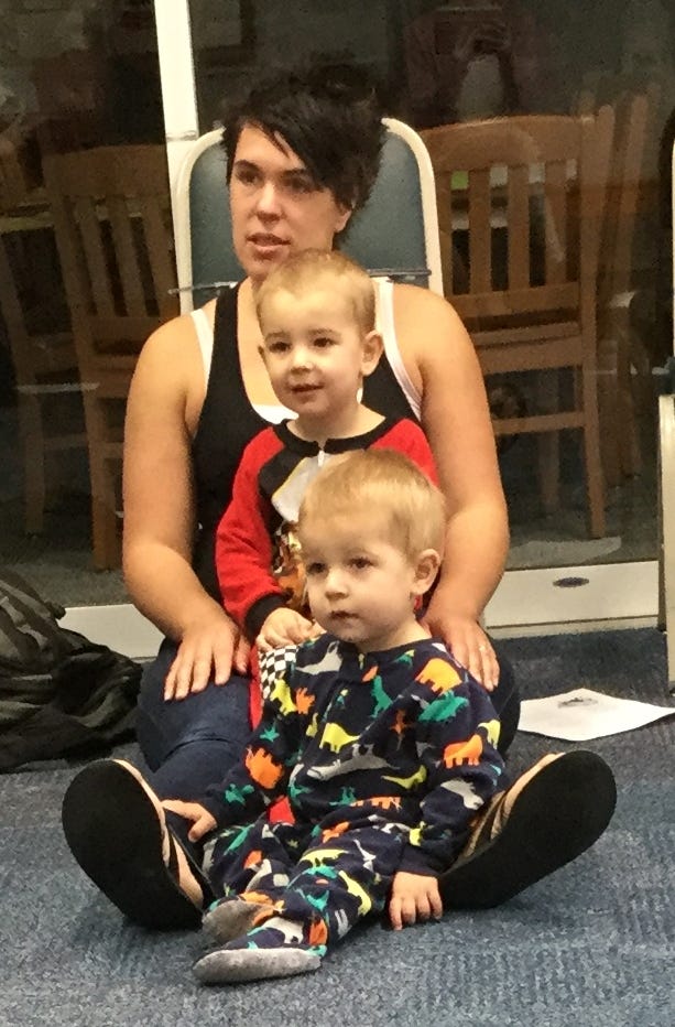 Amanda, Hunter (age 2) and Boone (age 1) Harrison listen during Library Class recently in Crestview. The boys are in their pajamas because the theme was "Bedtime." They are Crestview residents. [SPECIAL TO THE NEWS BULLETIN]