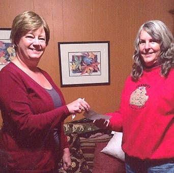 Becky Horne presents Ann Sprague with $1,000 for the Crestview Area Shelter for the Homeless. [SPECIAL TO THE NEWS BULLETIN]