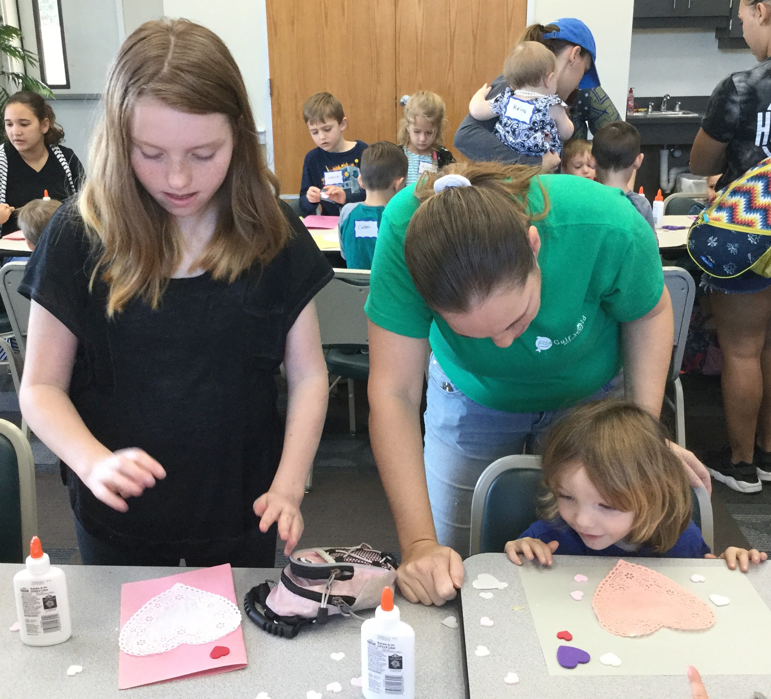 Kaitlyn, age 12, and Colten, age 3, make valentines with a little help from their mom, Christy Welch, just like Pete the Cat did in the book "Pete the Cat: Valentine's Day is Cool," by Kimberly and James Dean. The Welches attended the Feb. 6 class in Crestview. [SPECIAL TO THE NEWS BULLETIN]