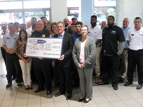 Allen Turner presents a $6,500 check on behalf of his employees to Crestview Police Chief Tony Taylor for the CPD's Cops For Kids Christmas toy program.