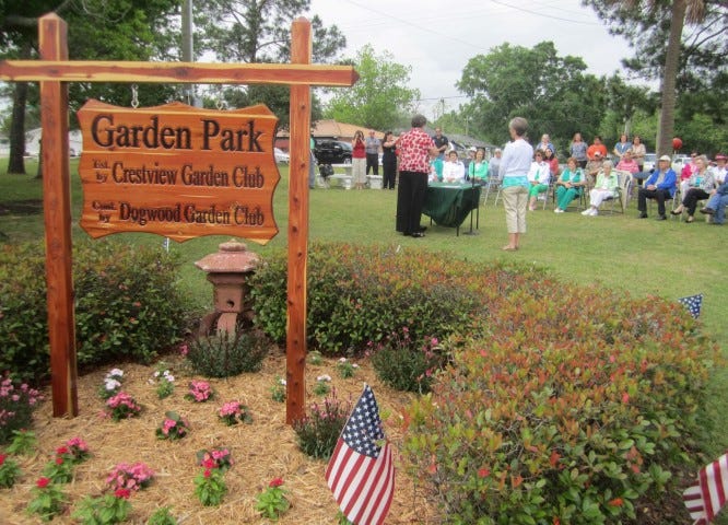 This red cedar Garden Park sign, crafted by Crestview High School alumnus Bill Walton, was officially presented during the April 25 park dedication ceremony.