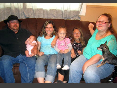 The Fouquet family, of Crestview, is grateful for three neighborhood heroes who aided them. From left are Jeremy Fouquet, cradling baby Reagan, family friend Amber Panitzke, Elizabeth, Alissa and Jessica Fouquet, and family dog Sweetie.