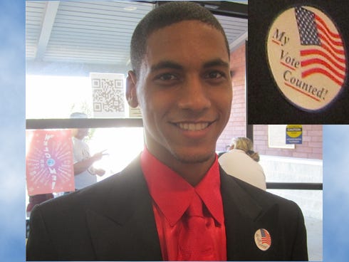 Carmine Harrell, 18, leaves polls at the Crestview Public Library after casting his first-ever vote Saturday morning. Inset: He received a sticker that says, "My vote counted!"