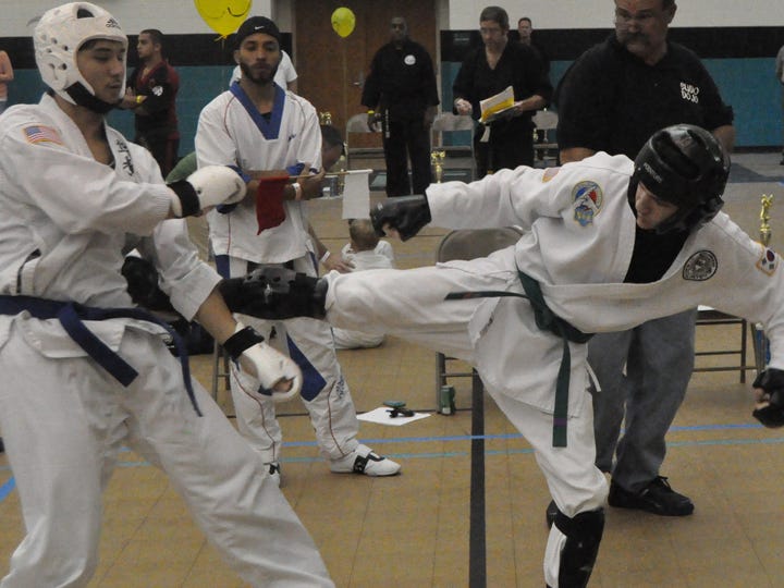 Christopher McFarland of Crestview, left, and Bryan Thomas of Cantonment, right, compete in sparring Saturday at the 2012 Northwest Florida Fall Martial Arts Championships.