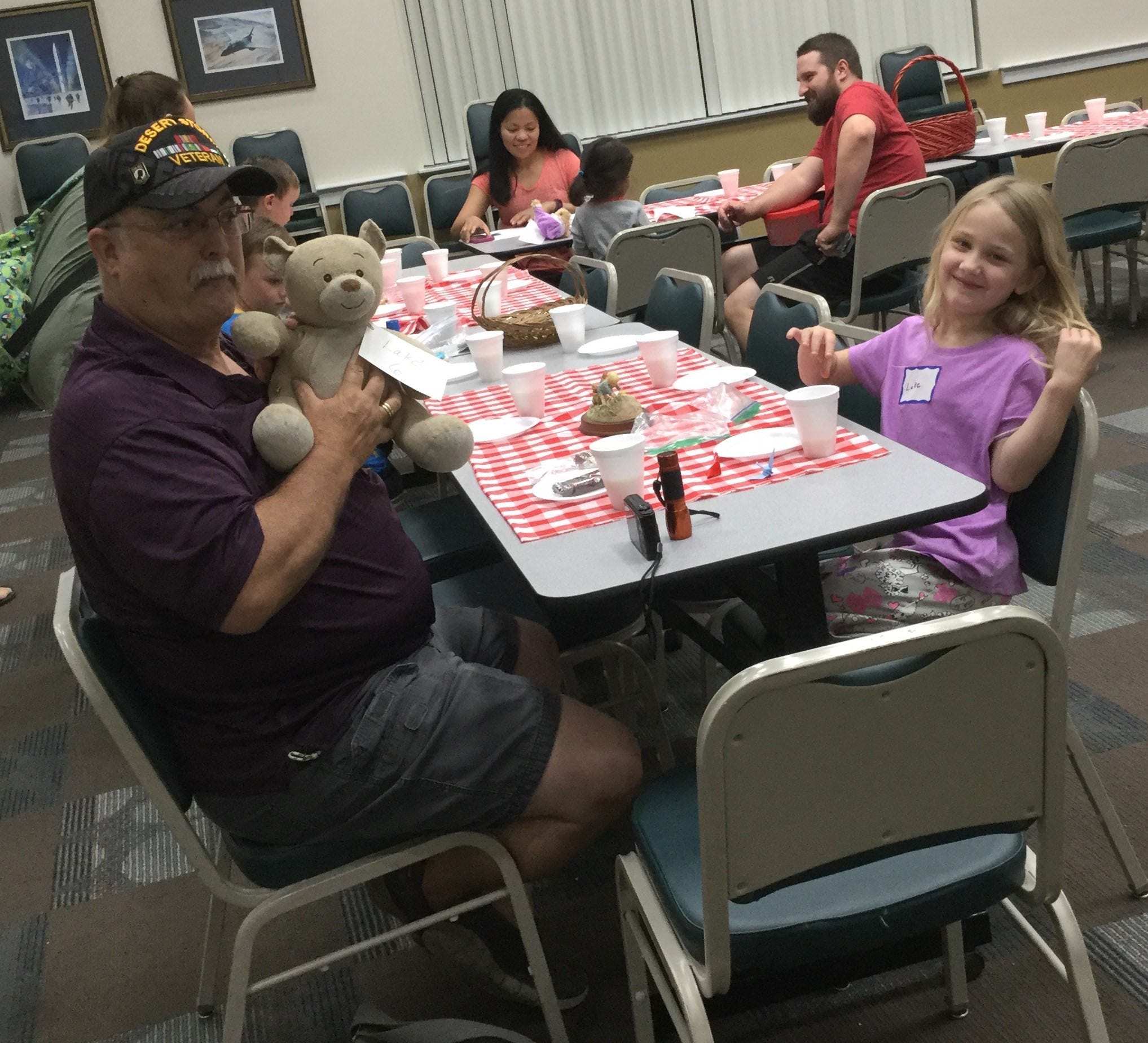 Lake Montoya, age 6, of Crestview, took her teddy bear and her grandpa, Gary Pritchard, of Laurel Hill, on a Bear Hunt Feb. 23 in Crestview. After her teddy explored the library and Lake found him, they enjoyed a picnic together. [HEATHER NITZEL | SPECIAL TO THE NEWS BULLETIN]