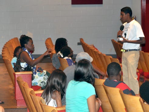 Adam Chinnasami, 14, answers questions from the audience during his presentation on Red, Orange, Green, a program that helps children develop nutritious eating habits.