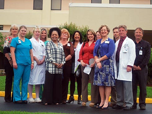 A number of North Okaloosa Medical Center staffers observed Donate Life Month with an April 14 flag-raising ceremony at the East Redstone Avenue hospital. 
Pictured from left: Jane Stearns, LifeQuest Organ Recovery Services of Florida's senior hospital services coordinator; Samantha Via, NOMC's ICU director; Nina Perez, NOMC's chief nursing officer; LeAnn Holcombe, NOMC's Cardiac Cath Lab director; Darlene Haynes, patient counselor; Teresa Balcerak, NOMC's HR coordinator; Sherrie Scott, lab director; Lesley Lang, Life Net Health of Florida; Jennifer Bray, staff development coordinator; MeLinda Isphording, NOMC's chief quality officer; Andy Jones, NOMC's Bio Medicine division; Gary Davis, NOMC's director of Cardiopulmonary Service; and Tom Schleusner, NOMC's director of Maintenance and Engineering.