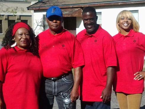 Doris Hill and Elder Gary Johnson, left — who organized the Brotherhood of Love's Thanksgiving feast — join the Revs. Albert and Kareca Wright — who provided space for it at Great Faith Ministries in downtown Crestview — during the Nov. 26 event.
