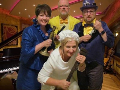 Paula Hilton's newest show, "Murder Without A Clue," features Mrs. Whitewash (with the Monkey Wrench), front row, and, from left, Mrs. Poppycock (with candlestick), Colonel Custard (with the pistol), and Professor Prune (with the dagger), all in the music room.