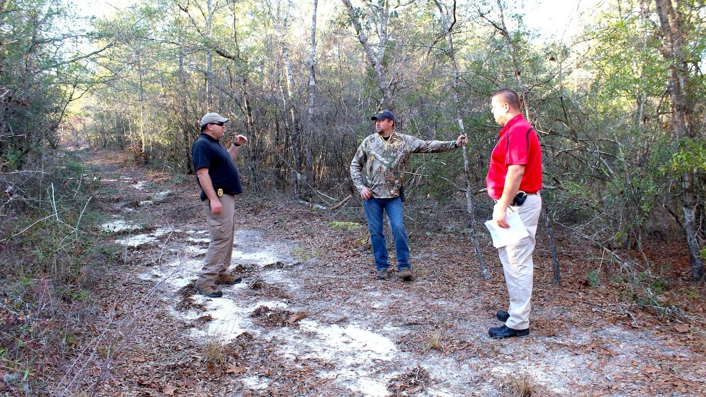 Investigator Shawn Temple (left), Investigator Chaise Rawles (middle) and Commander Andrew Schneider visit the 30-acre property being cleared for a shooting range. [SPECIAL TO THE NEWS BULLETIN]