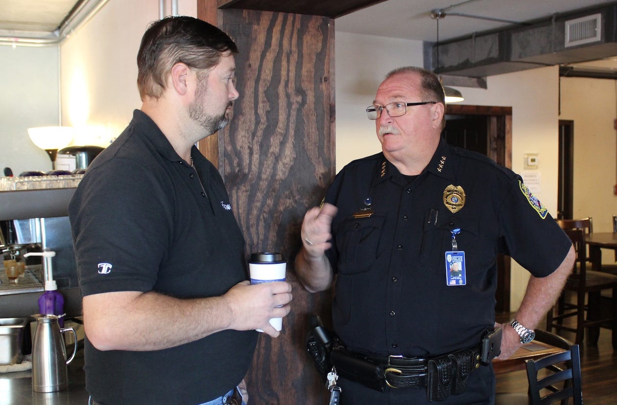 Main Street merchant Joey Forrest J. Tinklepaugh Jr. chats with Crestview Police Chief Tony Taylor during this morning's Coffee With a Cop at Casbah Coffee Company. [SPECIAL TO THE NEWS BULLETIN]