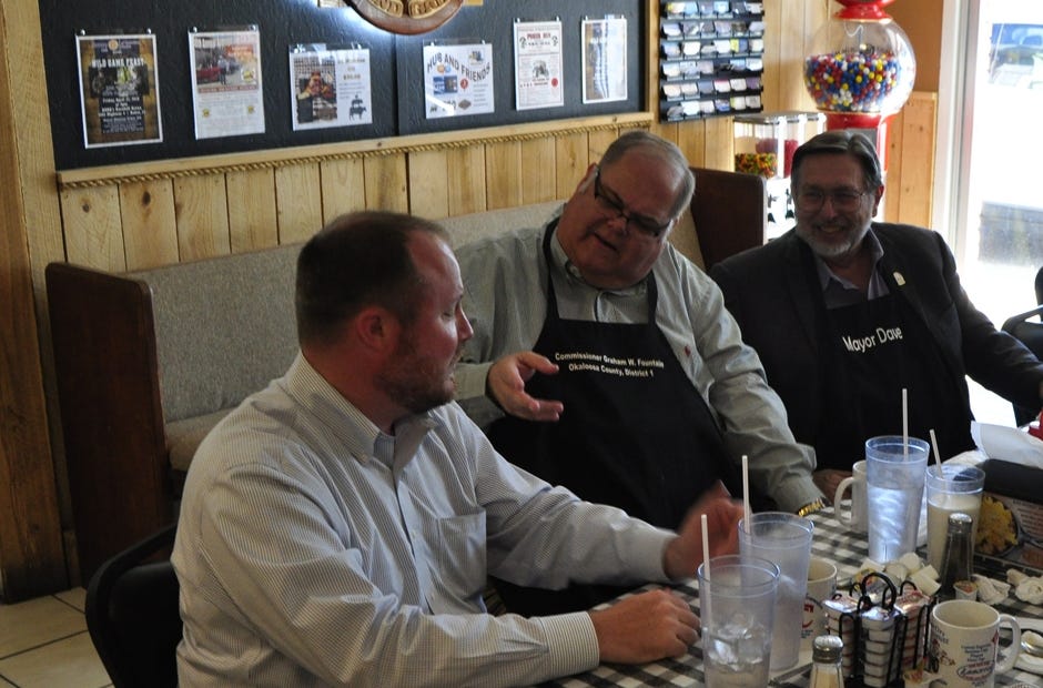 State Representative Matt Caldwell (left) talks with County Commissioner Graham Fountain (middle) and Mayor David Cadle (right). Caldwell is running for Florida Commissioner of Agriculture. [AARON JACOBS|NEWS BULLETIN]