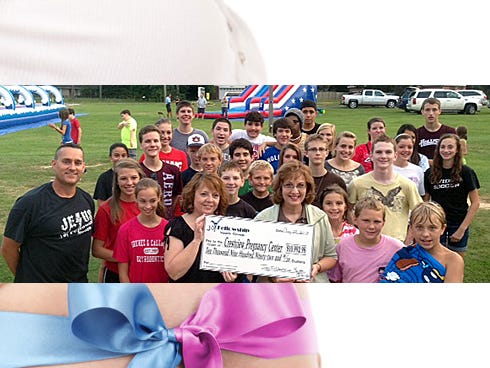 Joy Fellowship youth group and church members recently presented a $10,992.98 check to the Crestview Pregnancy Center.