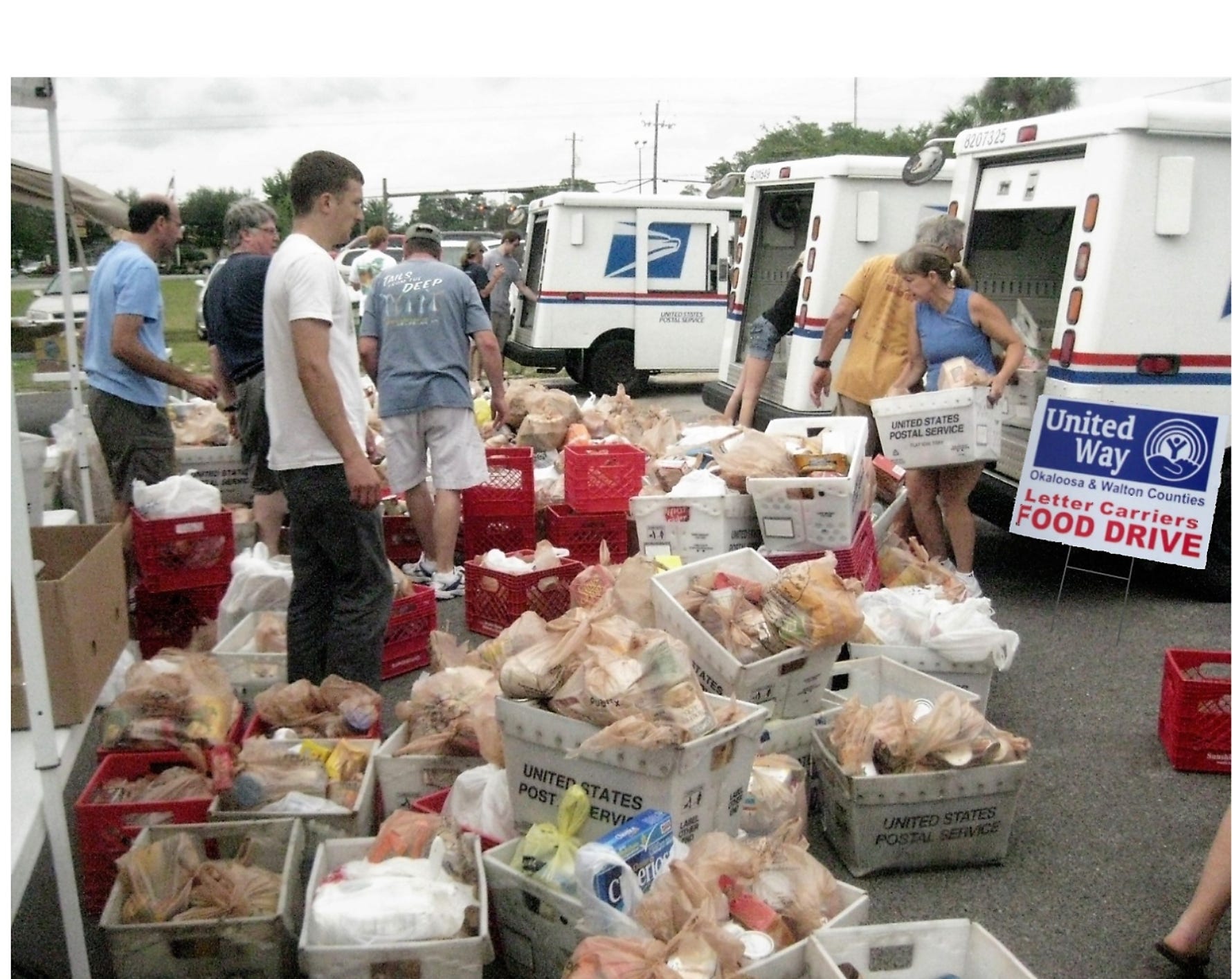 Volunteers participate in a National Association of Letter Carriers “Stamp Out Hunger” Food Drive. [Special to the News Bulletin]