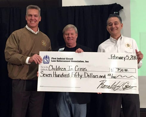 The First Judicial Circuit Law Enforcement Association donated $750 to Children in Crisis to support the children's education requirements. From left are Okaloosa County Sheriff Larry Ashley, representing 1st JCLEA, Ken Hair, Children in Crisis president and CEO, and Ronald Gay, association president.