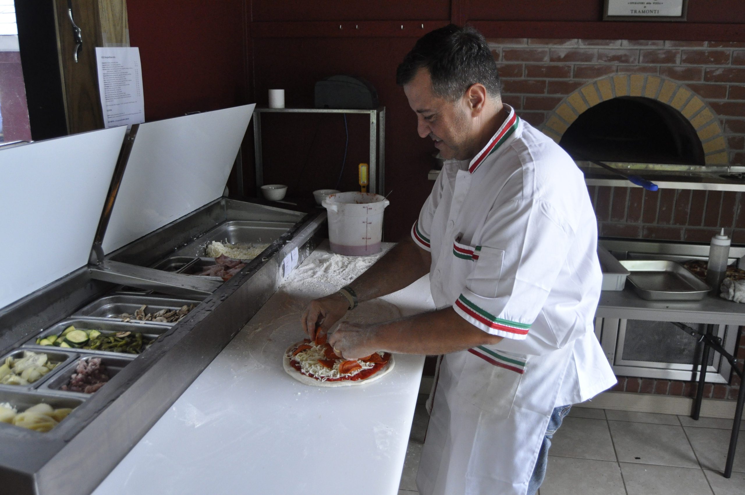 Giuseppe Vitagliano prepares a pizza on his restaurant's opening day. Vitaliano Pizza, Pasta & More opened May 21 in Crestview. [AARON JACOBS|NEWS BULLETIN]