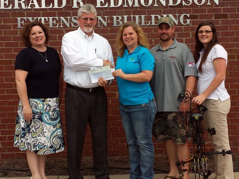 Legacy Insurance — a Crestview agent of Gainesville-based Tower Hill Insurance — donated $1,500 to Okaloosa County's 4-H program. Pictured, from left, are Dawn Mann and Allen Bell of Legacy Insurance; Misty Smith, Okaloosa County 4-H Extension agent; and George and Carrie Cook, volunteer 4-H Archery Club leaders.