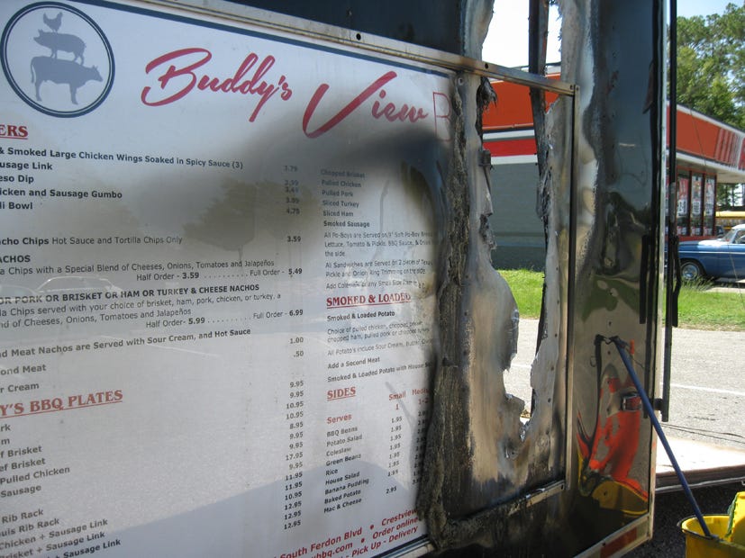 A July 29, 2014, fire at Buddy's View BBQ burned through the trailer's metal skin and damaged its south end. Friday, pitmaster Naaman Eicher will serve free barbecue to Crestview firefighters to thank them for saving the business by their fast response.