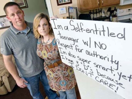 “We just got to the point where we just didn’t know what else to do,” said Renee Nickell, pictured here with husband Gentry and the sign their daughter held Saturday at the intersection of State Road 85 and U.S. Highway 90 in Crestview. The couple came up with the punishment because their daughter had become increasingly disrespectful at home and school and as a result her grades were suffering, they said.
