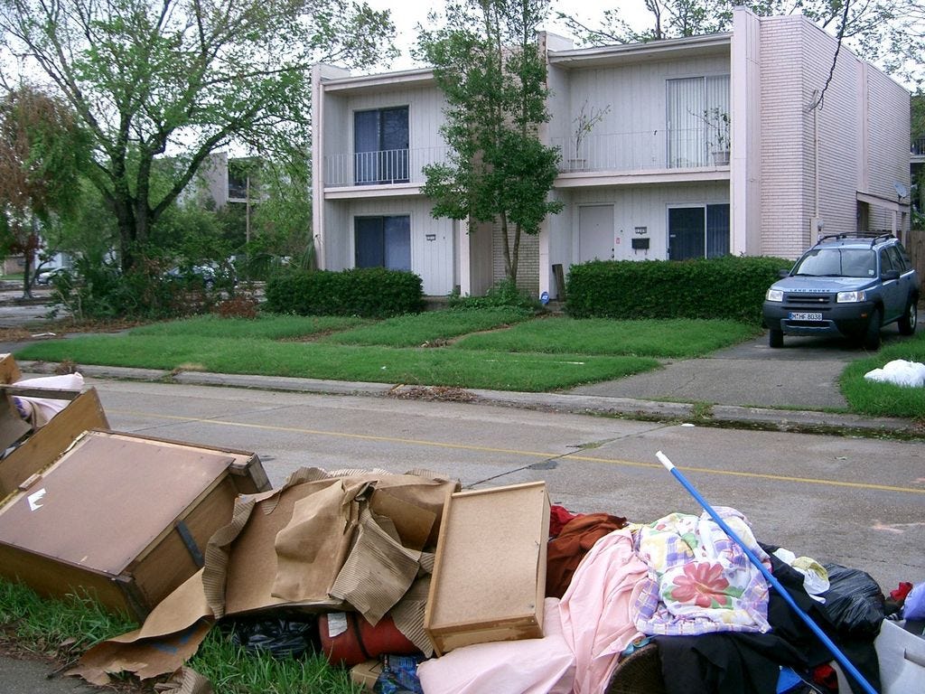 Three weeks after Hurricane Katrina, neighbors' storm-sodden debris lines Carrollton Avenue across the street from News Bulletin writer Brian Hughes' former Metairie, Louisiana, home. The apartment complex behind his house was razed after it partially collapsed in the storm.