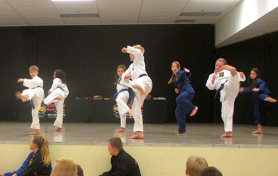 Intermediate taekwondo students demonstrate forms (routines) before advancing to the next belt Friday night. [BRIAN HUGHES | SPECIAL TO THE NEWS BULLETIN]