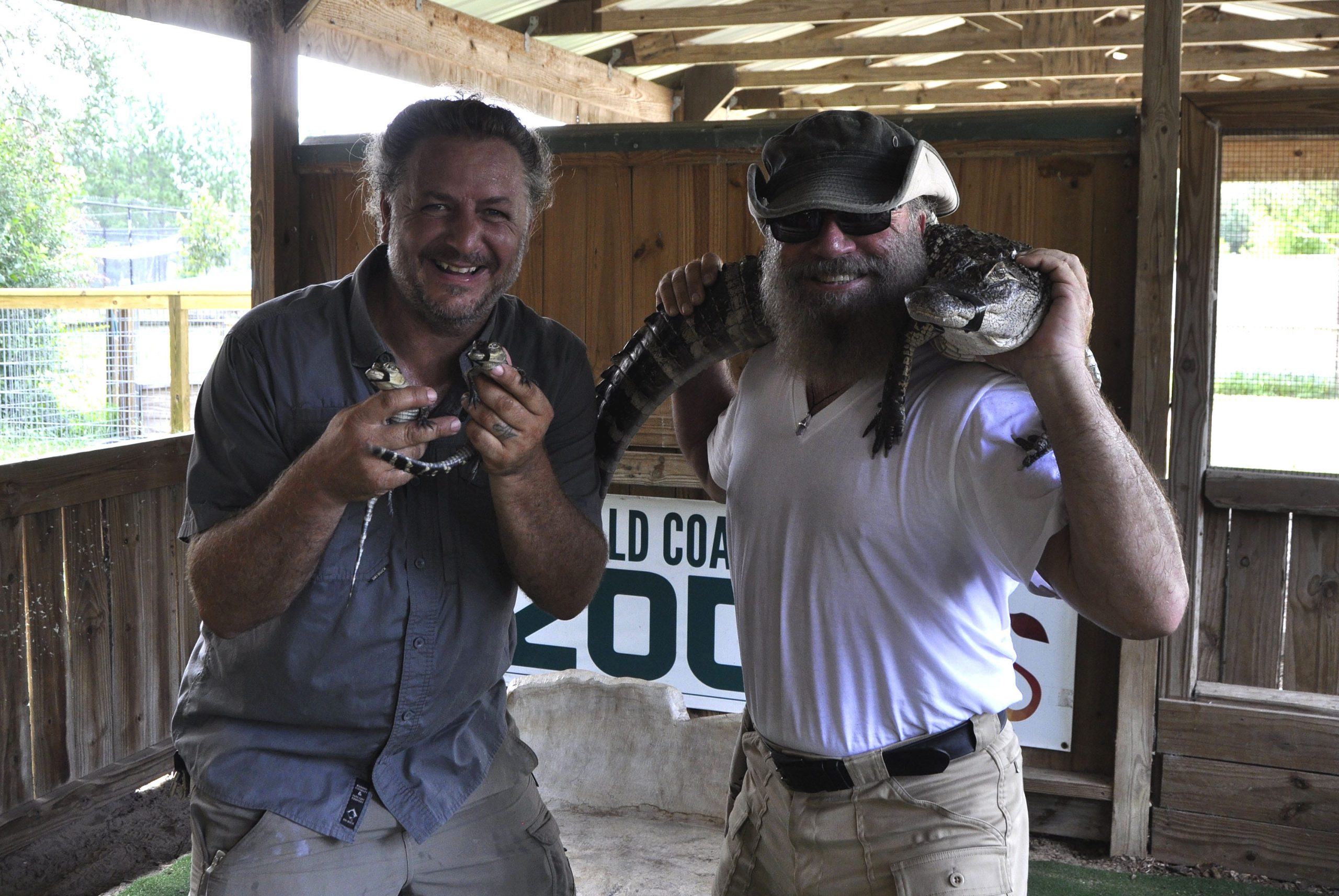 Rick de Riddler holds two baby alligators while John Decker holds Ali, the four foot alligator. The gators are some of the newest members of the Emerald Coast Zoo.

[KAYLIN PARKER/NEWS BULLETIN]