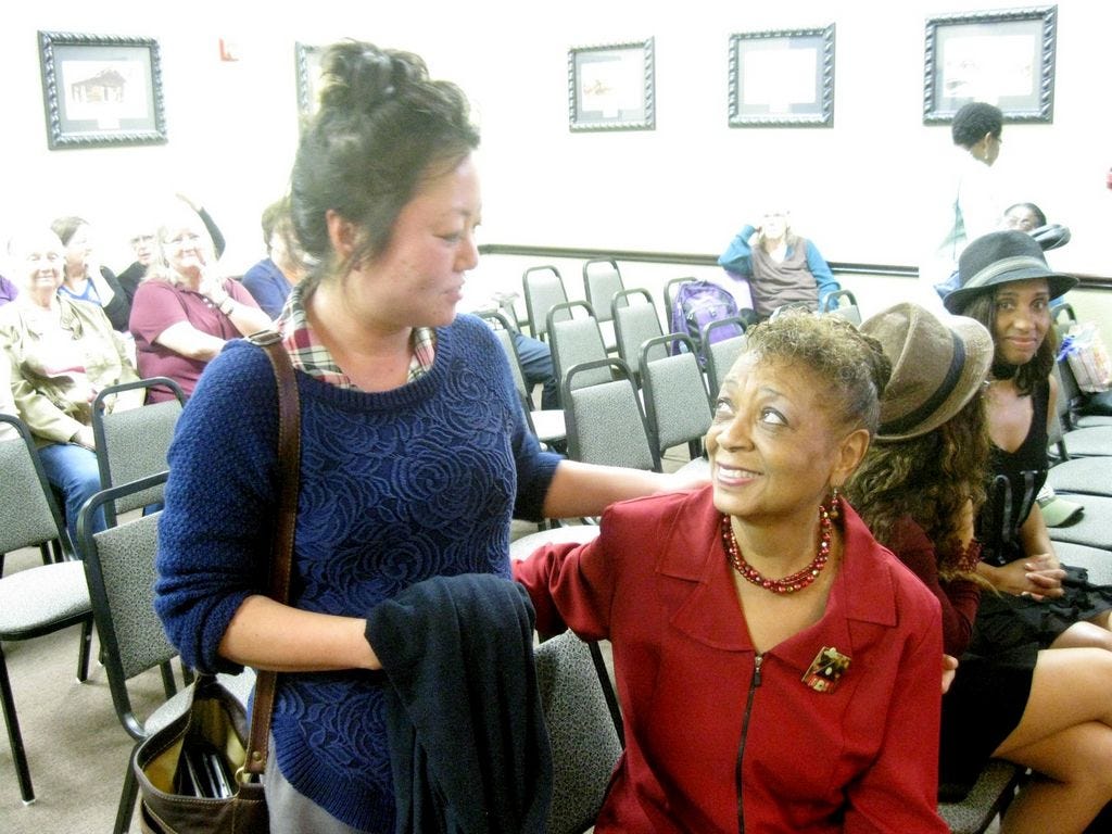 Incoming Crestview Public Library Director Marie Garcia chats with her retiring predecessor, Jean Lewis, at a special City Council meeting held in Lewis' honor Monday night.
