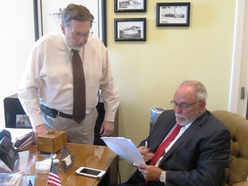 Crestview Mayor David Cadle and Peter Gutierrez — dean of Florida International University's new Herbert Wertheim College of Medicine physician assistant program — discuss the program's Crestview clinical rotation component on Thursday at city hall. The PA program's progress is on track, despite the death of former state senator Durrell Peaden, its most ardent supporter, the men said.