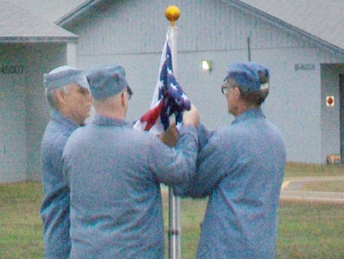 Inmates and former military members begin a reveille, or morning, ceremony at Okaloosa Correctional Institution in Crestview.