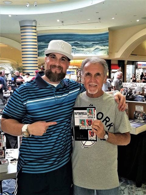 J.J. McDaniel, left, stands with his dad, Jerry, at a recent book signing. Jerry bequeathed his entire baseball card collection to his son because he wanted to see him enjoy it while he was alive. That collection inspired J.J.'s second book. [SPECIAL TO THE NEWS BULLETIN]