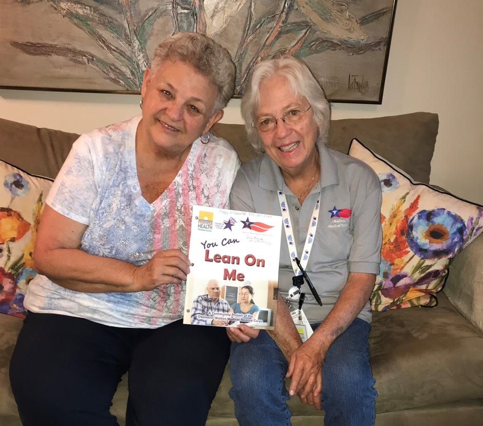 Okaloosa-Walton Medical Reserve Corps volunteer and Lean on Me Project Coordinator Peggy McDeavitt poses with a community member during a Lean on Me visit after teaching her how to complete her individual emergency plan. [SPECIAL TO THE NEWS BULLETIN]