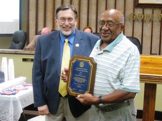 Malcolm Haynes, right, receives this year's Mae Retha Coleman Citizen of the Year Award from Mayor David Cadle.