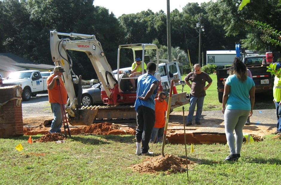 After recovering Rita Florence's mailbox (pictured at left), workers continued uncovering sections of fire hydrant pipe. [RENEE BELL | NEWS BULLETIN]