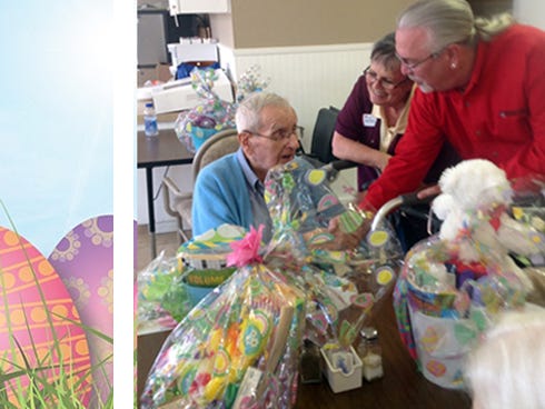 Ann O’Connor, of Emerald Coast Hospice, and Carl Kelley, Jackson Hewitt Tax Service franchise owner, present a "Basket of Blessings" on Thursday to World War II veteran Michael Labick.