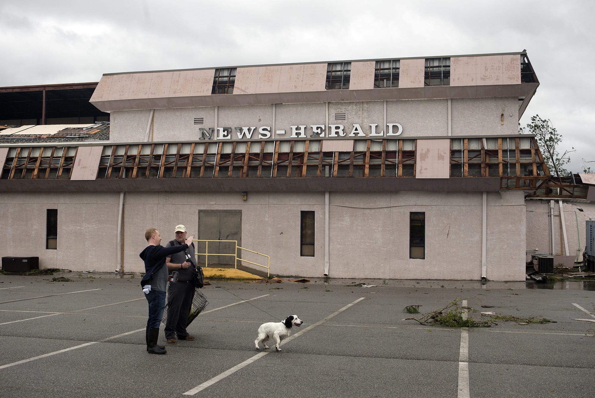 Panama City News Herald editor Mike Cazalas, right, and reporter Patrick McCreless plan their next move after Hurricane Michael on Wednesday, Oct. 10, 2018. The building suffered damage from the high winds, including losing part of the roof over the printing press. The Santa Rosa Press Gazette is also printed here. [JOSHUA BOUCHER/THE NEWS HERALD]