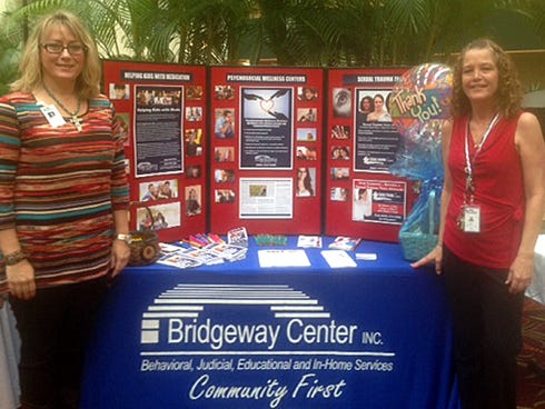 Bridgeway Center Inc. associates Karen McGavin, left, and Donna Morgan present informational materials during a National Association of Social Workers appreciation luncheon this month at The Meridian at Westwood, a senior retirement community in Fort Walton Beach.