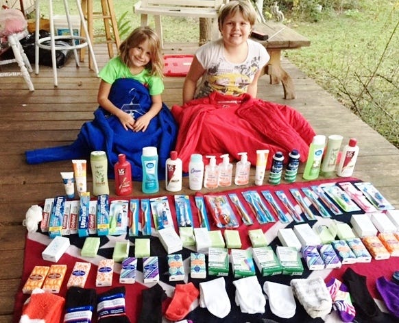 First cousins Alyssa Pursley, 10, and Kiera Murrell, 7, display some of the donations they’ve received for the homeless. The girls will collect donations through Dec. 14.