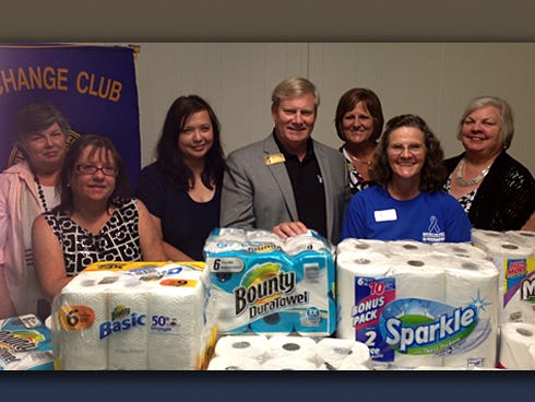 The Crestview Exchange Club donated a mountain of paper products to Children in Crisis for use in its five foster homes. CIC President Ken Hair stands with club members — Carolyn Knudson, Cheri Pittman, Liezele Wtulich, Karen Helms, Kathy Warren and Sharlene Cox — with their donations.