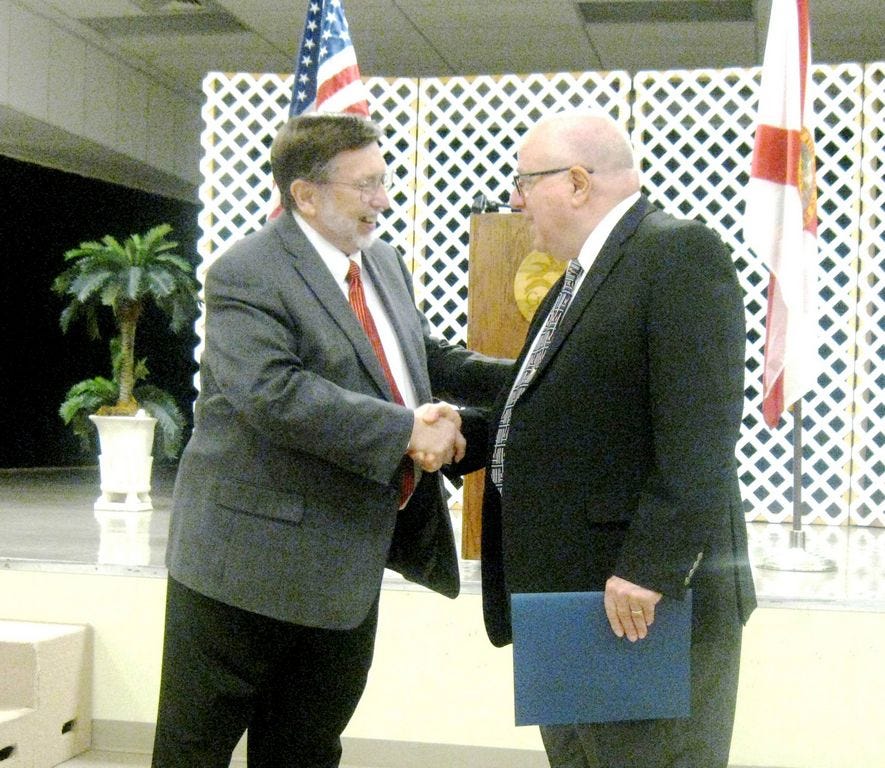 Mayor David Cadle congratulates local aviator Bob Keller upon proclaiming April 7 as Bob Keller Day in Crestview.